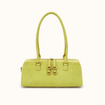 A light yellow-green leather handbag with double top handles and gold-tone hardware, shown against a plain white background.